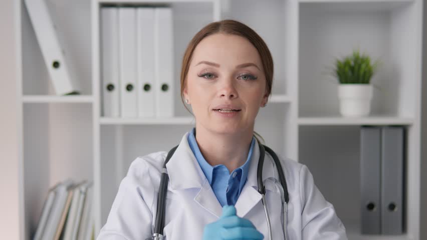 The doctor conducts an online conference, shares her knowledge, and provides medical care via video call. With the help of a webcam, a psychotherapist conducts remote sessions of psychological support Royalty-Free Stock Footage #3410358553