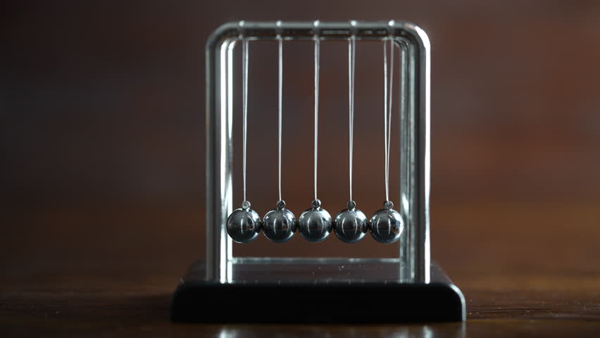 Metal Newton cradle placed on wooden background as representation of momentum concept, cradle balance steel balls, school teaching supplies, desk toy, gifts home decoration Royalty-Free Stock Footage #3410372057