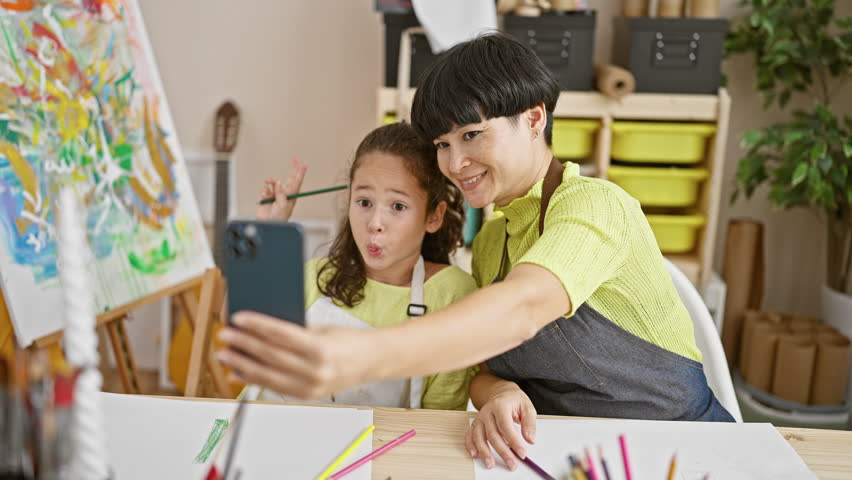 Art studio adventures, artist teacher and student drawing in notebook, making smiling selfie on smartphone together