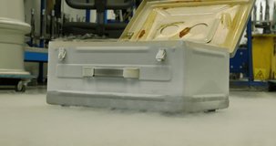 Cryogenic reaction: liquid nitrogen vaporizing from the vintage metal box. Close-up 4K footage of scientific marvel and extreme temperature reactions
