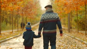 Little boy and his grandfather are having a walk in the autumn park - Powered by Shutterstock - Get 15% off with code: PIKWIZARD15