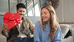 Boyfriend embracing and giving his girlfriend a heart shaped box gift to celebrate Valentines Day. Young couple holding a suprise present on their relationship anniversary. Love and romance date. High - Powered by Shutterstock - Get 15% off with code: PIKWIZARD15