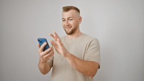 A handsome young man with a beard smiles while video calling on his smartphone against a white background.