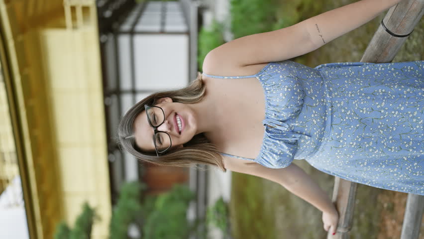Attractive hispanic woman, joy radiating from her beaming smile, stands confident and casual in her glasses at the breathtaking kinkaku-ji gold pavilion, a jewel of kyoto, japan