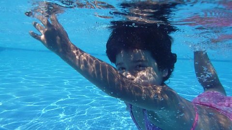 Happy active child in the swimming pool, underwater view Stock Video