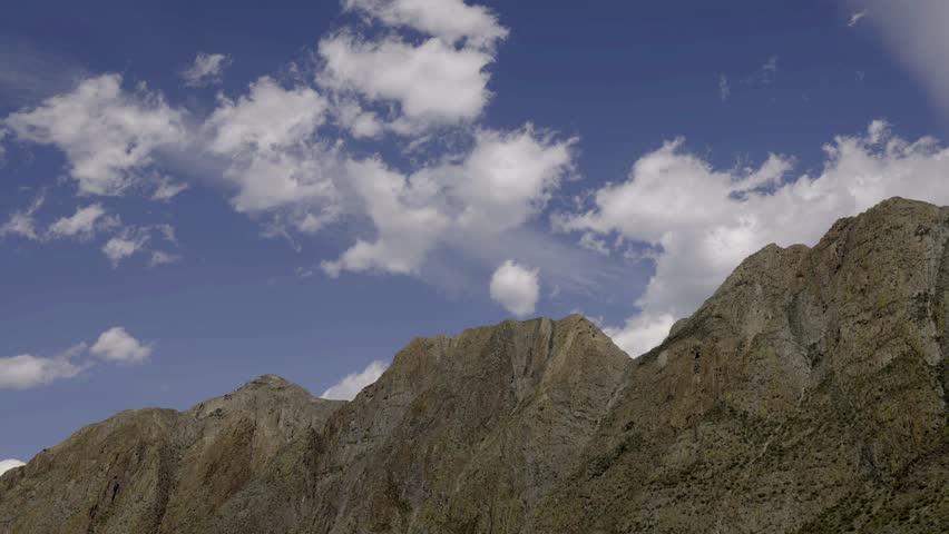 video with clouds mooving above rocks. majestic mountain landscape timelapse