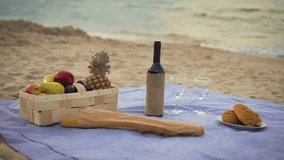 Closeup of summer picnic basket with fresh fruits and croissants wine bottle with glasses on tablecloth near ocean. Picnic outdoors at sea shore - Powered by Shutterstock - Get 15% off with code: PIKWIZARD15