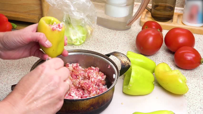 Preparing stuffed peppers. Stuffing peppers with minced meat. Step-by-step cooking video recipe. Culinary master class.
 Royalty-Free Stock Footage #3410818023