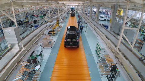 BELARUS, BORISOV - OCTOBER 19, 2017: Automobile plant, modern production of cars, car body assembly process, workers serve cars, automated production line. Timelapse, October 19 in Borisov, Belarus.