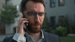 Close-up Caucasian businessman upset man male entrepreneur employer talking telephone outside unpleasant business conversation talk mobile phone connection discuss issues with client in city outdoors - Powered by Shutterstock - Get 15% off with code: PIKWIZARD15