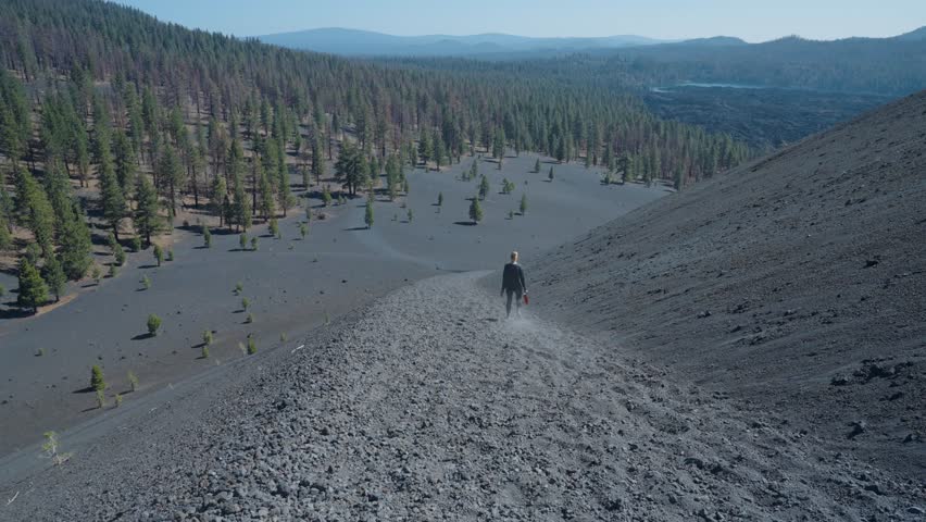 Woman hiking down ramp of Cinder Cone Trail in Lassen National Park