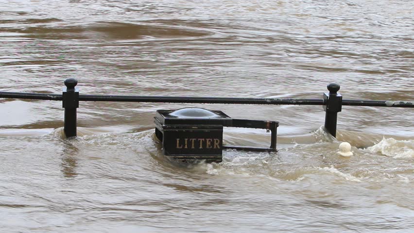 The River Severn overflowing its banks and covering a litter bin and railings. Bewdley. Worcestershire. December 2023. UK