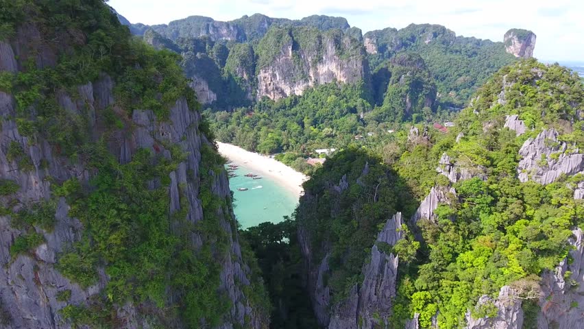 Cinematic Ariel Shots of Railay Beach Krabi Thailand going through cliffs revealing beach.  | Shutterstock HD Video #34110739