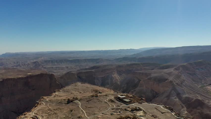 Aerial panoramic view of the Dead Sea and the ancient fortification Masada in the Southern District of Israel situated on top of an isolated rock plateau, eastern edge of the Judaean Desert, Israel