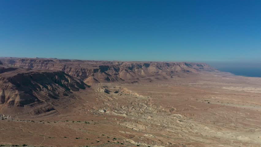 Aerial panoramic view of the Dead Sea and the ancient fortification Masada in the Southern District of Israel situated on top of an isolated rock plateau, eastern edge of the Judaean Desert, Israel