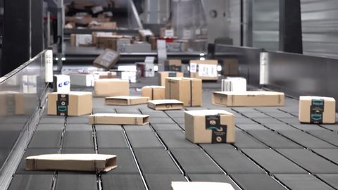 Huge amount of parcels bein transported on conveyor belt system: film stockowy