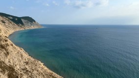 Panoramic view of the sea surface from the coast. Black Sea, Anapa, Krasnodar Territory, Russia. Sunset view of Bald Mountain near the village of Supseh. The beach has 800 steps. 4K Video