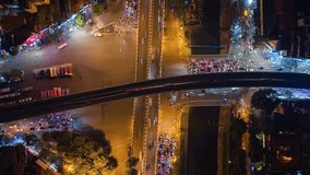 Vertical video. Aerial time-lapse of evening traffic at an intersection in Hanoi, Vietnam.