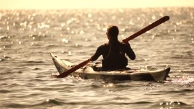 Woman sea kayak. Happy smiling woman in kayak on ocean, paddling with wooden oar. Calm sea water and horizon in background. Active lifestyle at sea. Summer vacation. - Powered by Shutterstock - Get 15% off with code: PIKWIZARD15