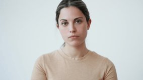 Video of of worried young woman thinking over white background
