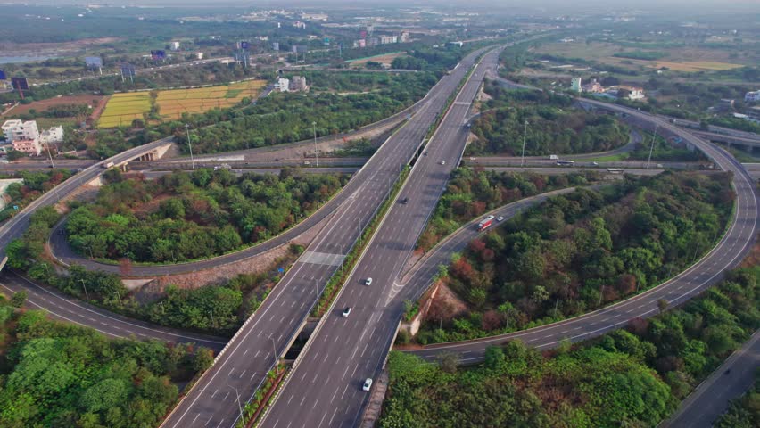 Spectacular Turning Overhead pull back drone Shot of nehru outer ring road Highway showing multiple Roads, Bridges, Viaducts with little car traffic in hyderabad, telangana, india Royalty-Free Stock Footage #3411394393