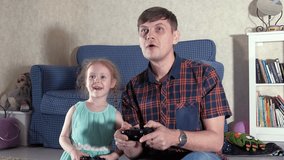 Couple and daughter playing at video game in their living-room 4k