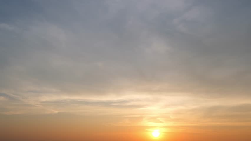 The sun's descent captured in fast-forward, clouds in perpetual motion. The sky's drama unfolds in a thrilling time-lapse, nature's spectacle. Loop footage. Timelapse.

