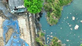 Industrial wastewater is a major water pollution source due to harmful chemicals and toxins discharged during manufacturing. Surface water pollution and microplastics concept. Aerial view.
