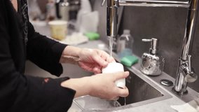 slow motion video of housewife use natural cleaning detergent to wash dishes.