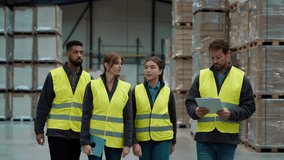 Front view of warehouse workers walking in warehouse. Team of warehouse workers preparing products for shipment. - Powered by Shutterstock - Get 15% off with code: PIKWIZARD15