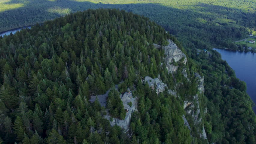 Mountain top covered in trees in Quebec, Canada. Aerial view. Beautiful summer day in the mountains.