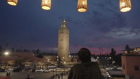 Marrakesh, Morocco - Man looking at Medina Old Town Cityscape and Minaret de la Koutoubia during Sunset - Powered by Shutterstock - Get 15% off with code: PIKWIZARD15