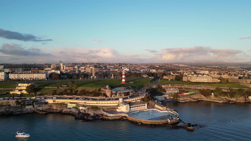 Aerial view of Plymouth at the sunset. Drone view of Smeaton's tower, Hoe Park, Plymouth Harbour Royalty-Free Stock Footage #3411771287