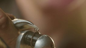 Extreme close up - a jeweler fixes a precious stone in a gold ring - Powered by Shutterstock - Get 15% off with code: PIKWIZARD15