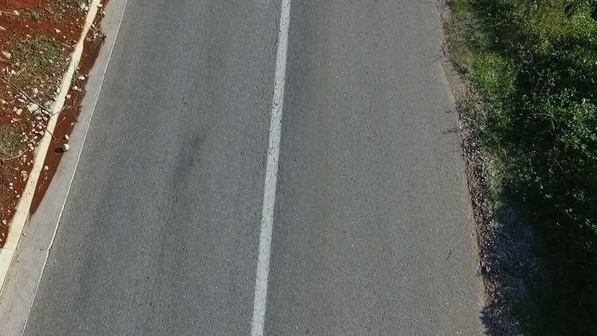 Outdoor shot of fitness woman running on open country road