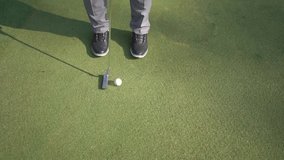 closeup to the ball, golfer hits the ball with stick