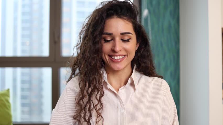 Beautiful mid adult woman making a video call