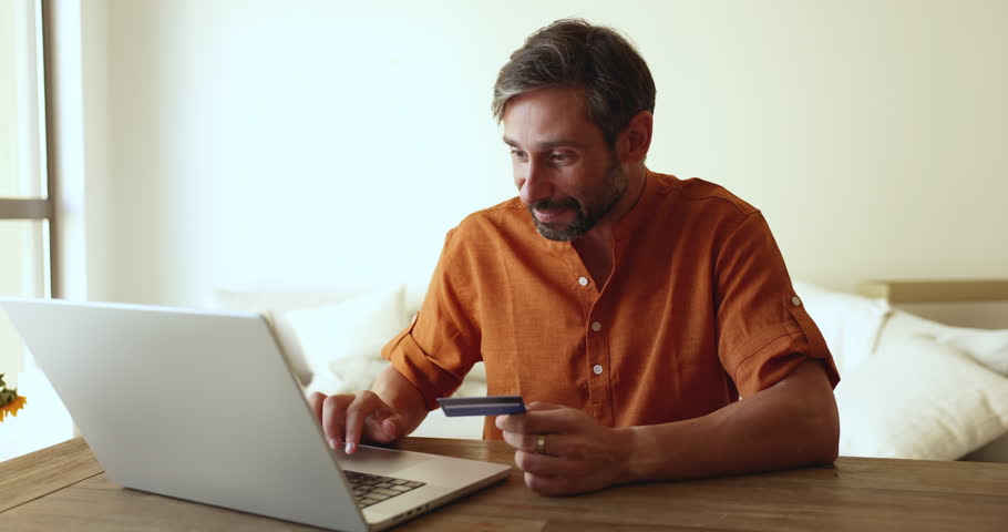 Mature man make on-line purchase enters card data pay bills through secure e-bank system, using easy, quick money transfer websites, ordering goods remotely. Electronic commerce client do e-shopping Royalty-Free Stock Footage #3411958653