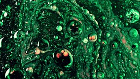 Background video abstract video texture mixing green and orange colors. fluid art painting slow motion video. High quality 4k footage