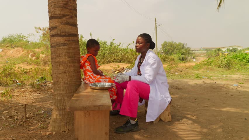 Africa children healthcare: woman black female nurse injecting vaccine to children in small village as prevention of disease, slow motion 