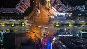Vertical video. Aerial time-lapse of evening traffic at an intersection in Hanoi, Vietnam.