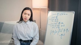 Asian teacher makes a math lesson online, live broadcast of the learning process, home education, homeschooling online by video call, young woman finished the lesson.