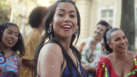 Exuberant Brazilian Carnival, Woman Reveling in Dance as Confetti Falls, Joyous Street Celebration with Friends 库存视频