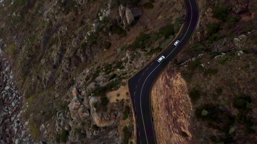 Car driving cliffside road. Chapman's Peak drive in cape town, south africa. Aerial view. Royalty-Free Stock Footage #3412220283