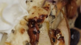 Freshly baked Italian pizza with pears on wooden table. Delicious recipe. Appetizing close-up shot of pizza maker chef placing a melted cheese pizza from the oven. - Powered by Shutterstock - Get 15% off with code: PIKWIZARD15