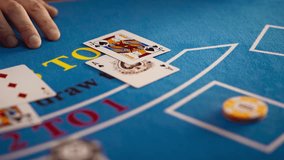 Close Up on Casino Baccarat Gambling Table: Anonymous Croupier Dealing Playing Cards on a Blackjack Table with Bet Chips in Place. Poker Chips are Being Exchanged as the Lucky Guest Wins the Jackpot - Powered by Shutterstock - Get 15% off with code: PIKWIZARD15