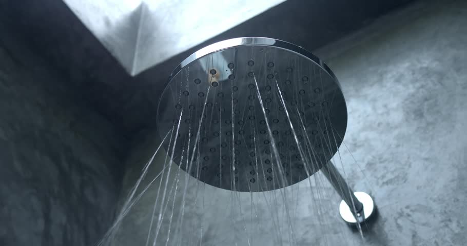 Shower head, flowing water in bathroom. Bottom view of holes in shower head built into gray bathroom wall. Water flows pouring slowly down from shower head. Using water, taking bath, douche, showering Royalty-Free Stock Footage #3412305105