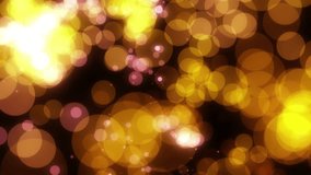 Golden yellow abstract video background with shimmering and randomly moving bokeh light flashes.
