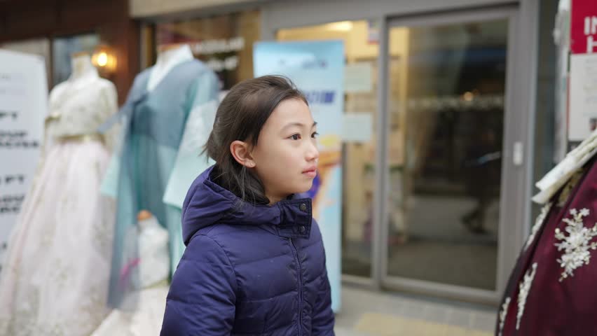Slow-motion video of a Korean girl walking in the city of Seoul, South Korea in a cold winter