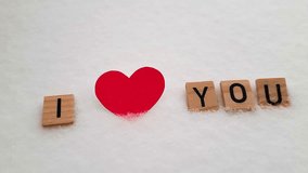Phrase I love you on wooden blocks. Theme of love. Loving, positive emotions. Wooden cubes with word and pink heart on a snowy background. An exclusive relationship. - Powered by Shutterstock - Get 15% off with code: PIKWIZARD15